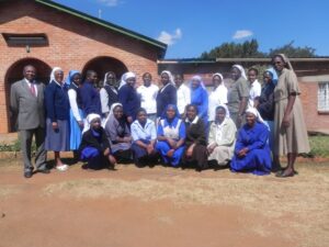 Participates Pose for a group phot with their Facilitator