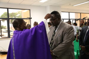 Lucias Banda receives Arshes from Fr. Chinkanda