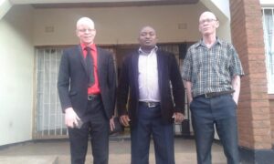 Chiphwanya (C) with Chair for the Association with people with Albinism (L) after meeting for a discussion