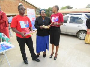 Dzikodaya (R) explains the uniqueness of the Bible to a Catholic Christian (C) as Henderson (L) looks on-Pix by ECM Communications Commission